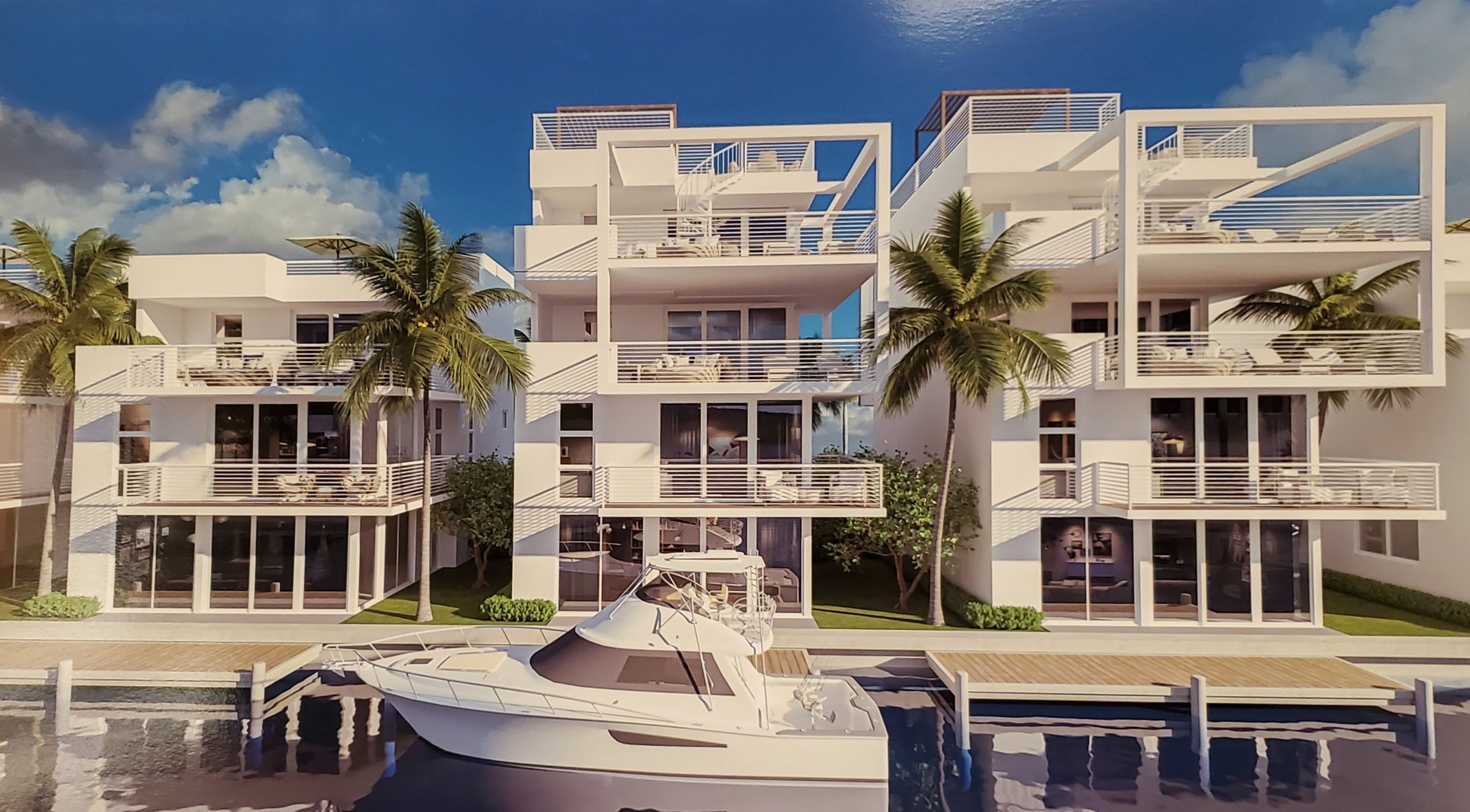 Proposed waterfront fish houses. Three-story waterfront residences are shown with deep balconies, rooftop terraces and individual boat slips directly in front of the homes.