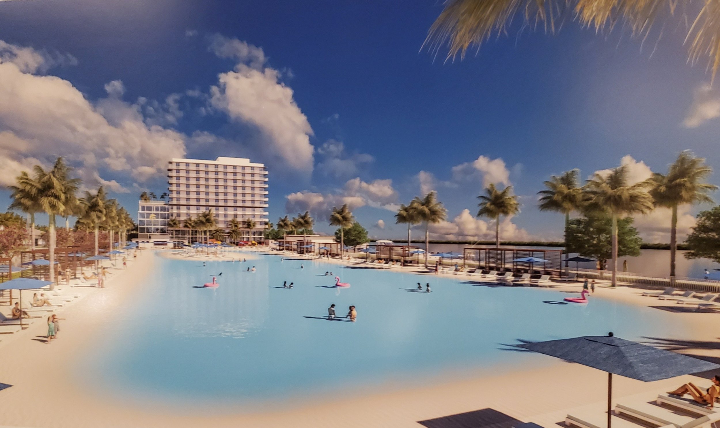 Resort lagoon and activity area. A broad lagoon anchors the resort concept, with a sandy edge, paddle activities, umbrellas, palms and a hotel or residential tower beyond.