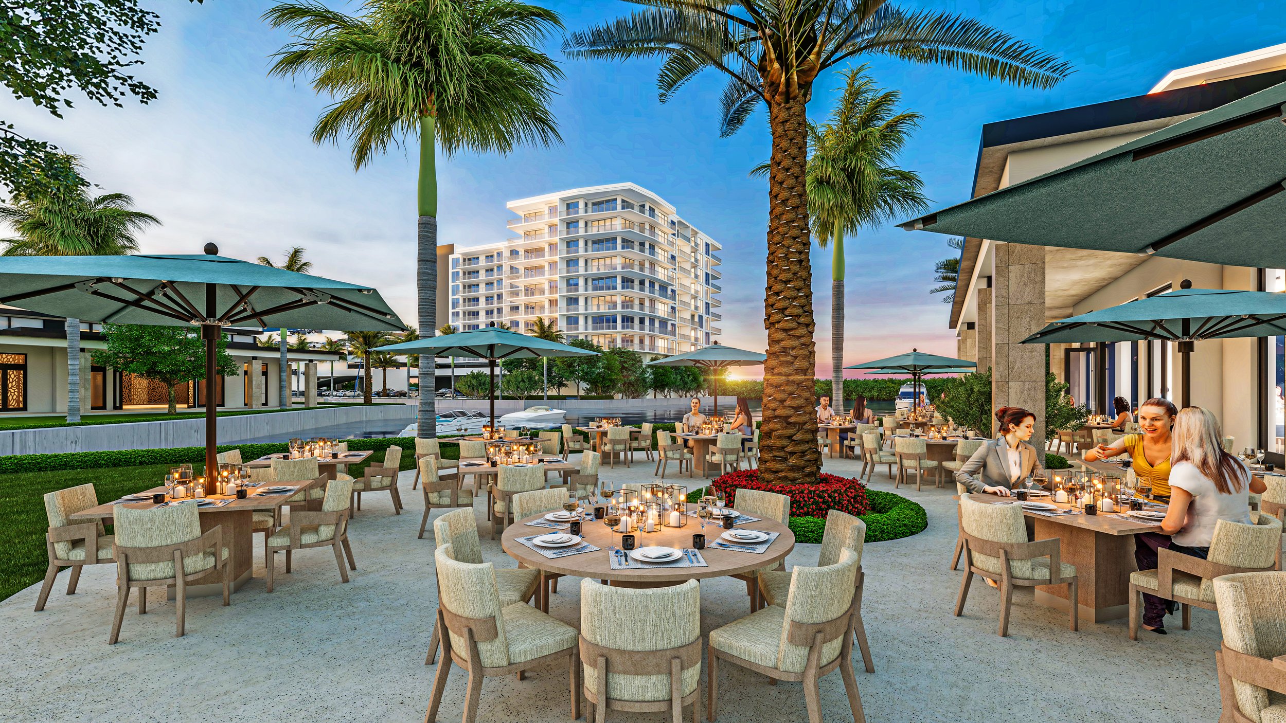 Waterfront dining and public gathering space. The rendering shows outdoor restaurant seating beneath shade structures and palm trees, with the lagoon and taller resort buildings in the background.
